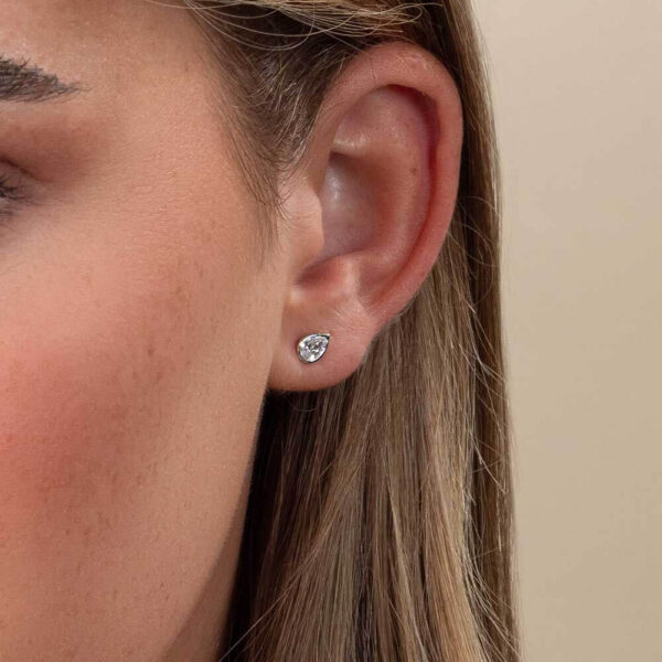 Model Wears Athena Pear Diamond Bezel Stud Earrings White Gold Cropped