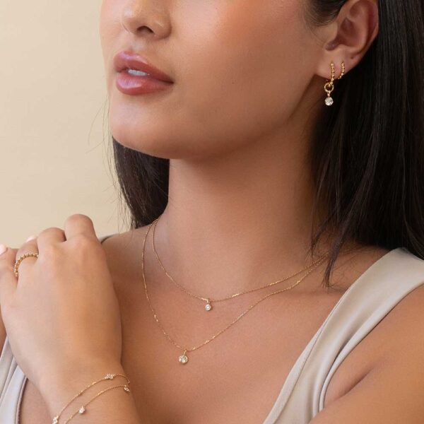 Model Wears Hope Hoops Yellow Gold Layered Lou Round Small Large Charm Veda Alternating Liliana Diamond Bracelet Cropped