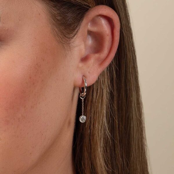 Model Wears White Gold Jen Round Medium Bezel Drop Diamond Earring Enhancer With Blair Large Plain Hoops Cropped