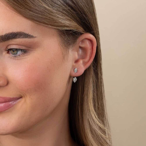 Model Wears White Gold Luna Pear Bezel Solitaire Earring Enhancer With Athena Diamond Bezel Stud Earrings Cropped