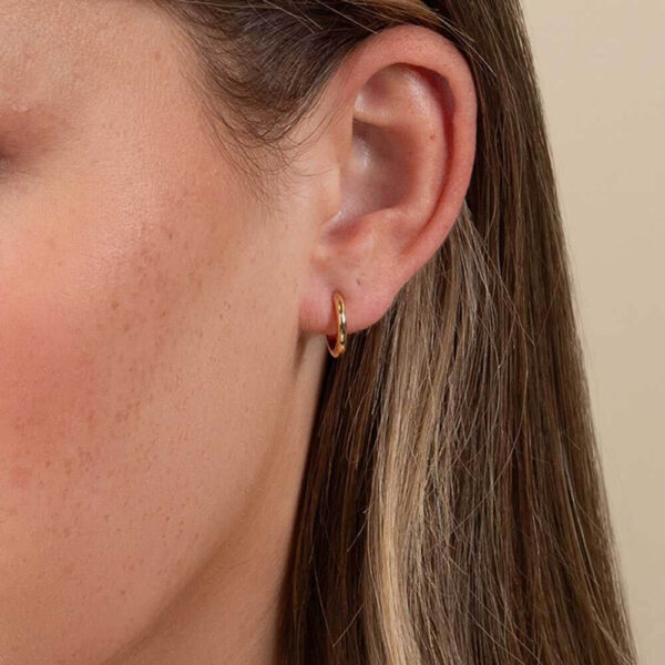 Model Wears Yellow Gold Blair Medium Plain Round Hoop Earrings Cropped