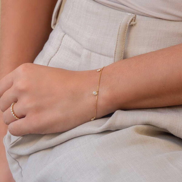 Model Wears Yellow Gold Liliana Round Bezel Drop Diamond Bracelet Cropped