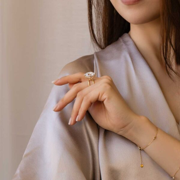 Model Wears Cassandra Yellow Gold East West Set Cushion Moissanite Double Band Ring