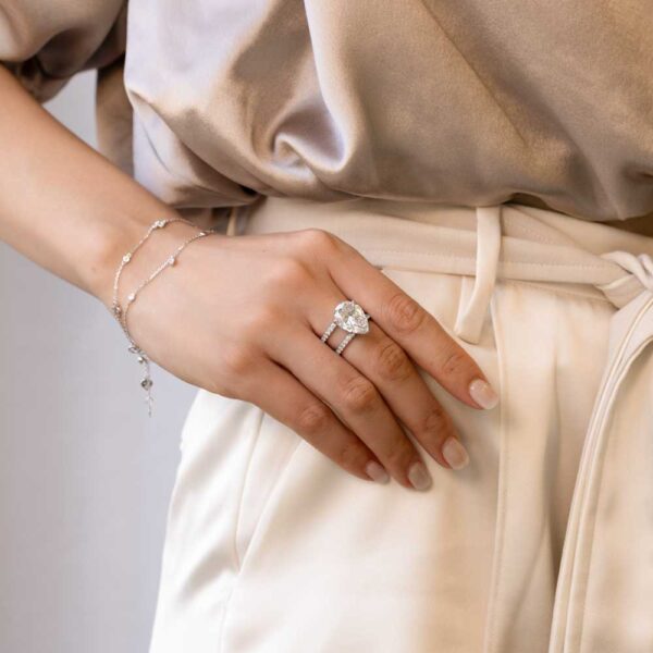 Model Wears Clarissa White Gold Moissanite Pear Under Rail Double Band Ring