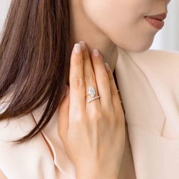 Model Wears Rochelle Lab Grown Diamond Marquise Asymmetrical Offset Band Yellow Gold Ring